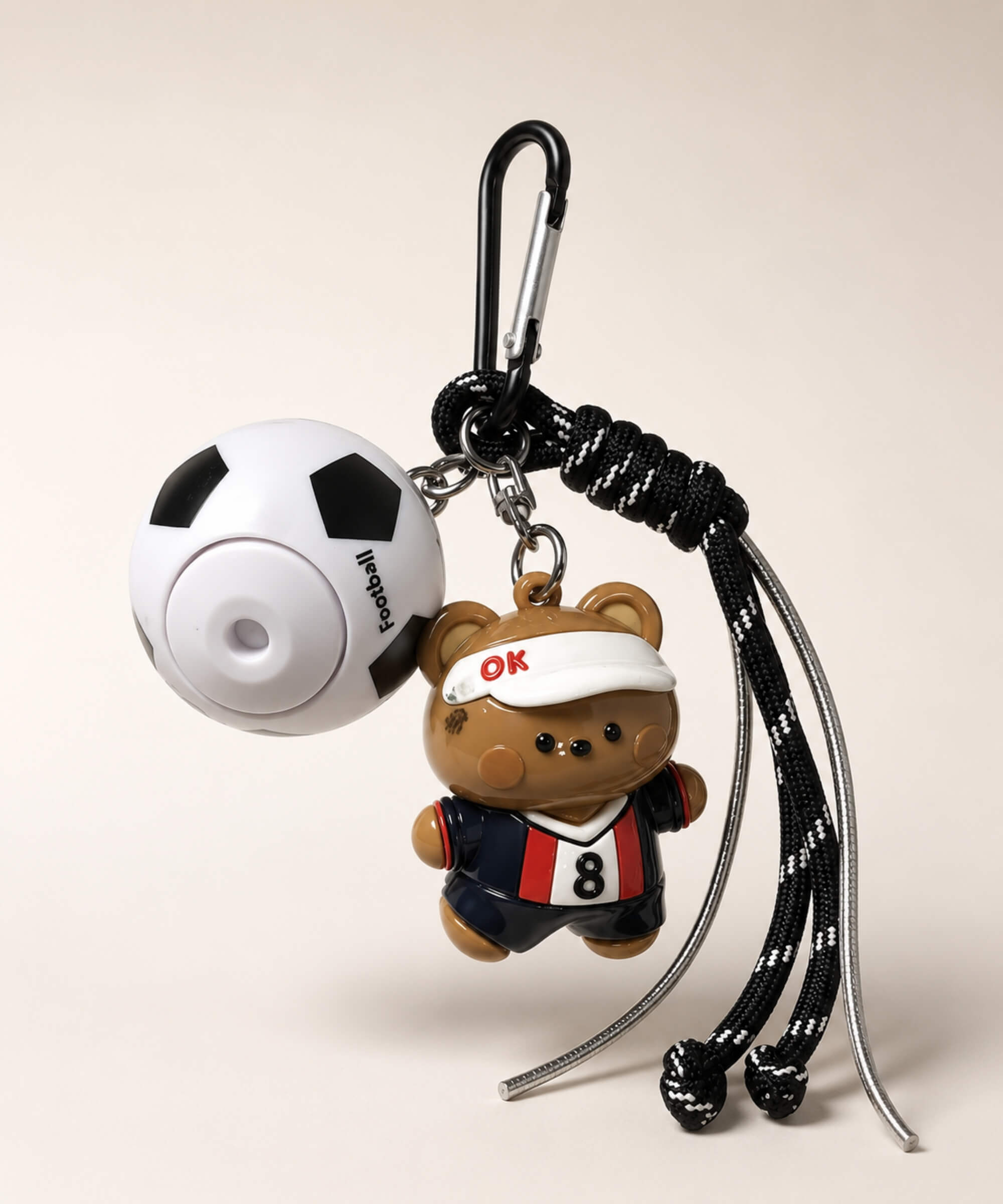 Brown bear soccer ball spinner keychain with football charm, black rope-style strap and carabiner clip